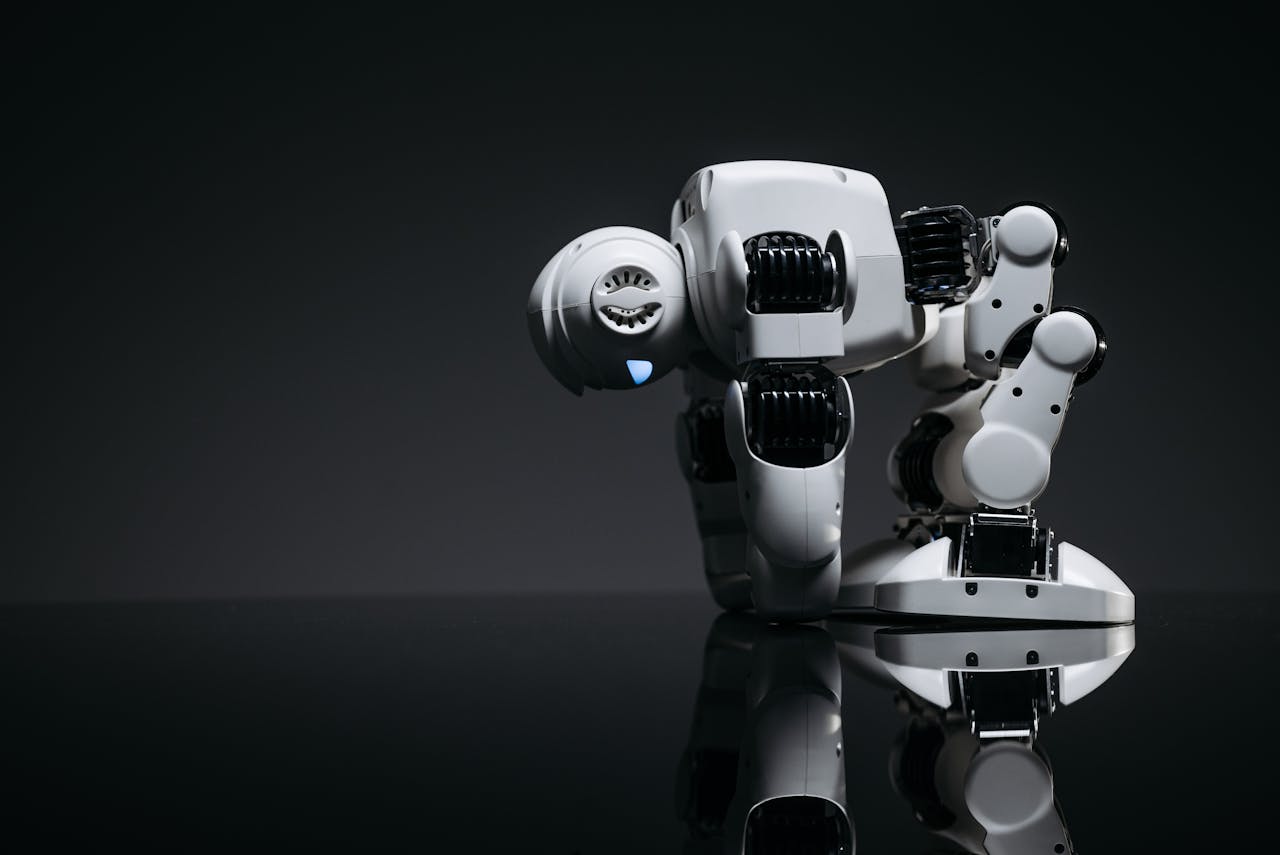 about-02 A modern robot toy depicted in a studio environment with its reflection visible on a dark surface.